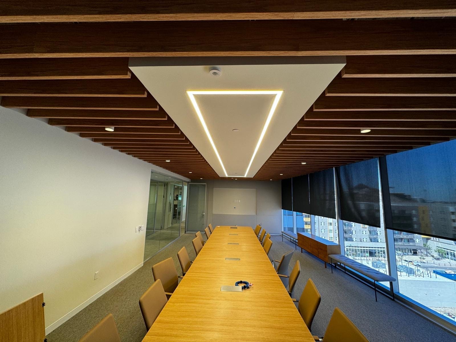 Boardroom with a warm wood-slat acoustic ceiling