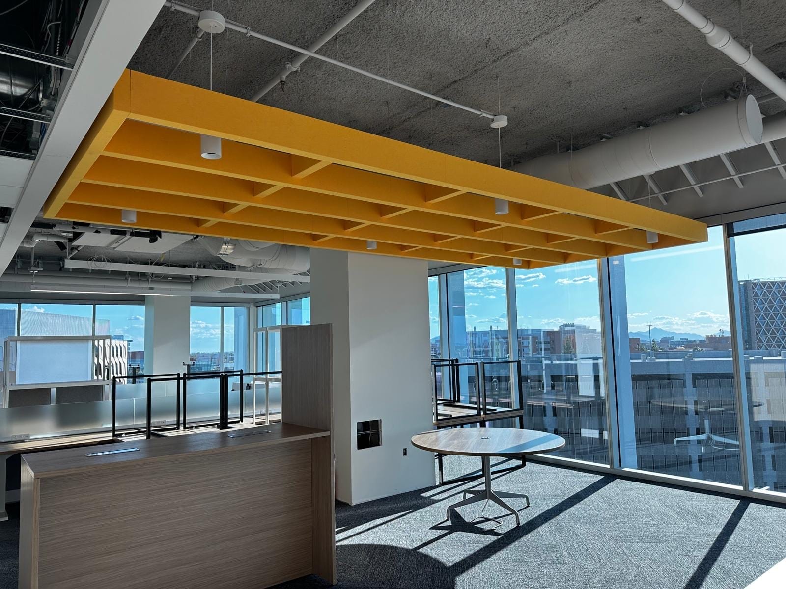 Yellow acoustic cloud above a reception and meeting area