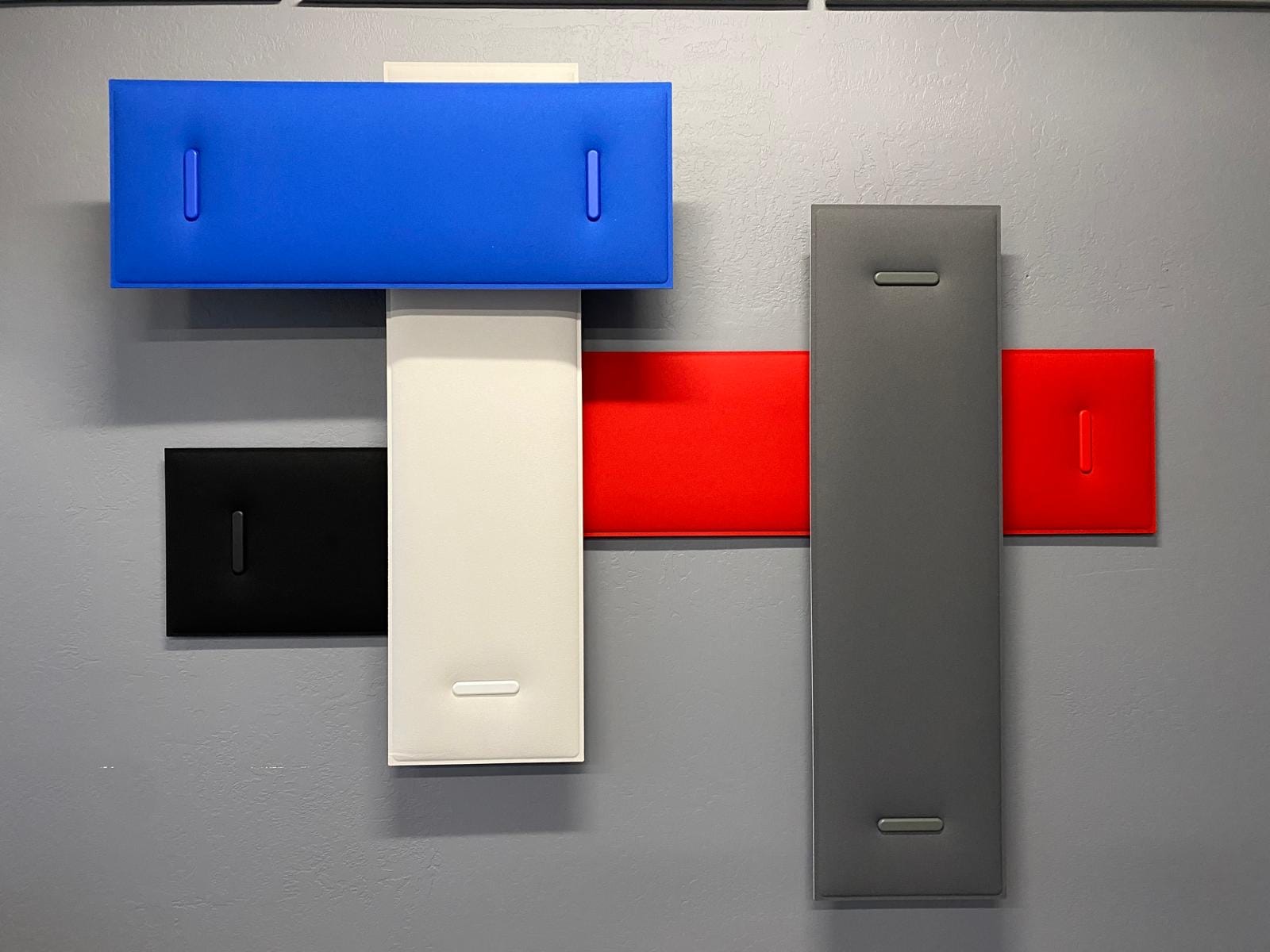 Acoustic panel color samples — blue, red, white, black and grey