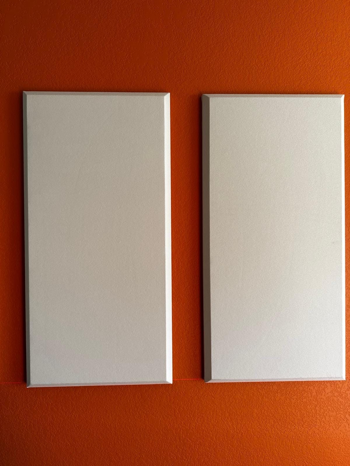 Close-up of two acoustic panels on a media-room accent wall