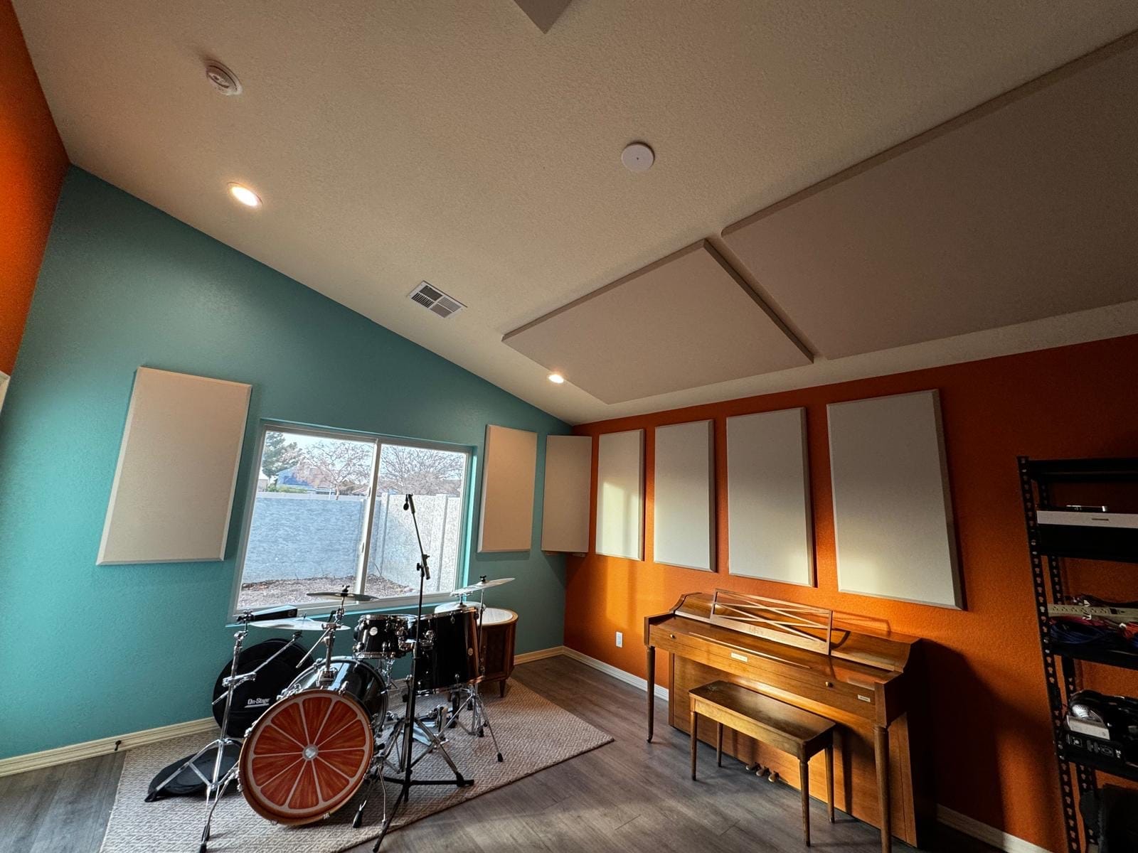 Home media room with wall and ceiling acoustic panels, drums and piano